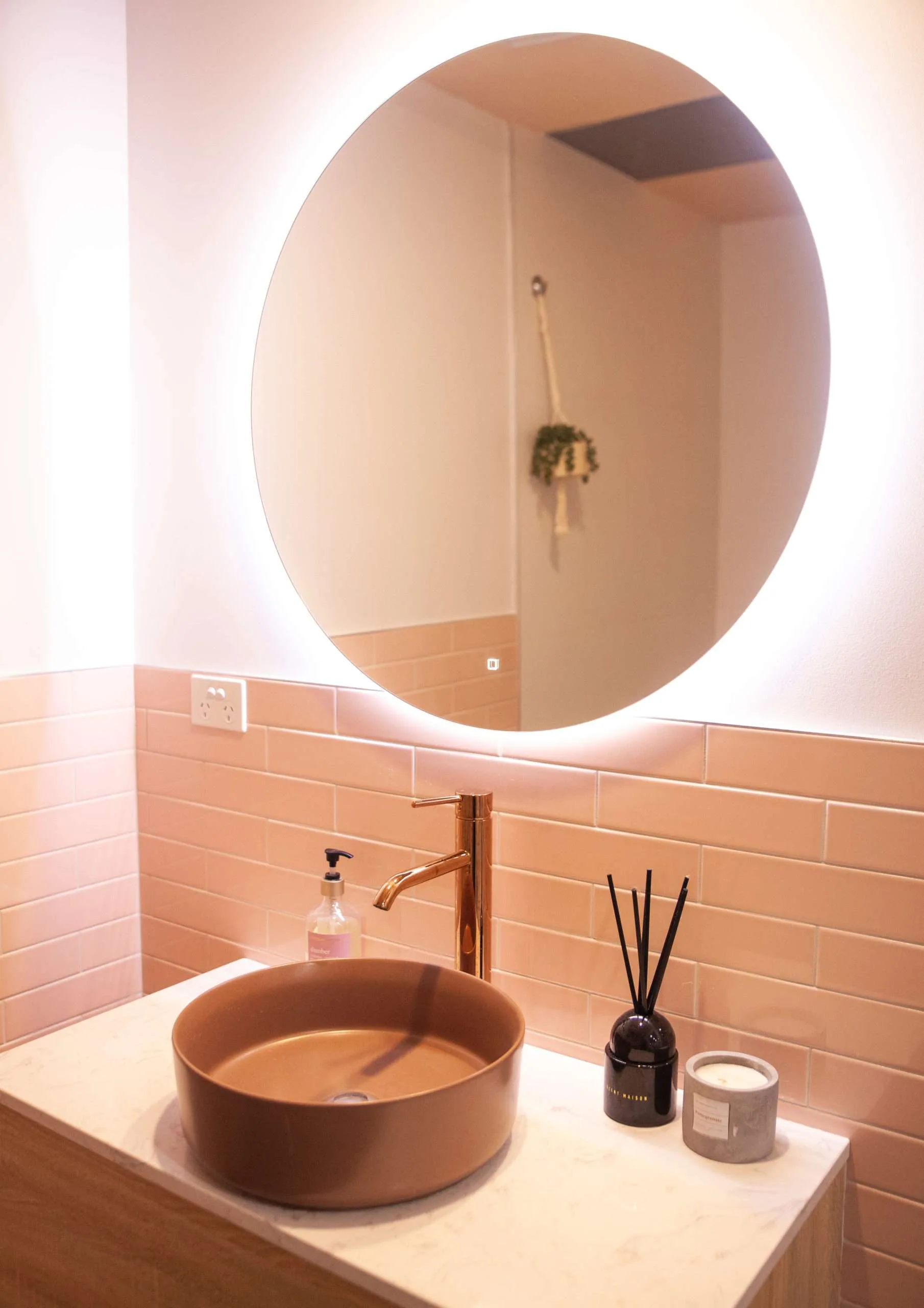 Studio bathroom with terracotta basin and blush tiles